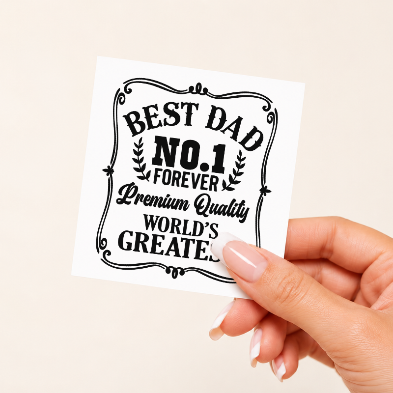 Hand holding a card with 'Best Dad No. 1 Forever Premium Quality World's Greatest' text on a beige background