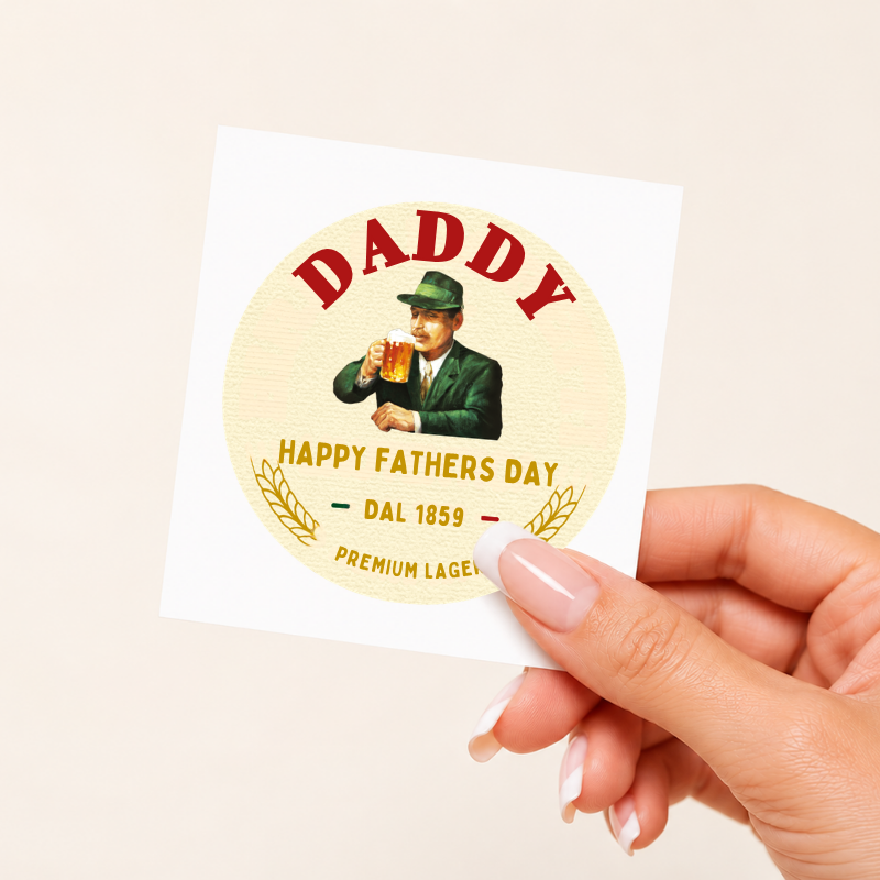 Hand holding a Father's Day card with a vintage-style illustration of a man and text.