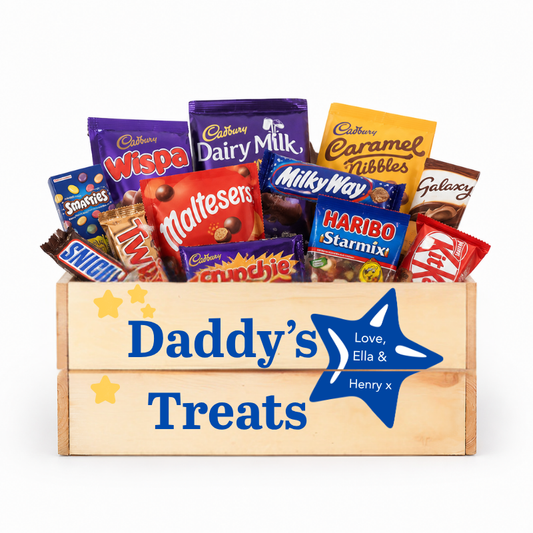 Wooden box filled with various candy bars and labeled 'Daddy's Treats' on a white background