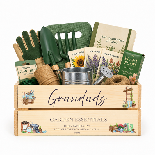 Gardening gift set with tools, seeds, and books in a wooden crate labeled 'Grandad's Garden Essentials'.