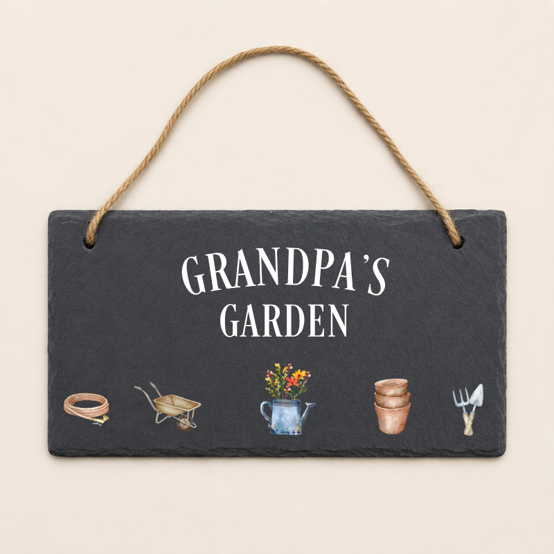 Slate sign with 'Grandpa's Garden' text and gardening illustrations on a beige background