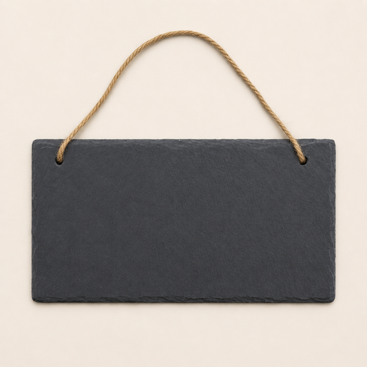 Rectangular slate sign with a rope hanging on a beige background