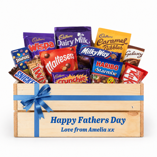 Wooden crate filled with various candy bars and a blue ribbon, with 'Happy Fathers Day' text on a white background.