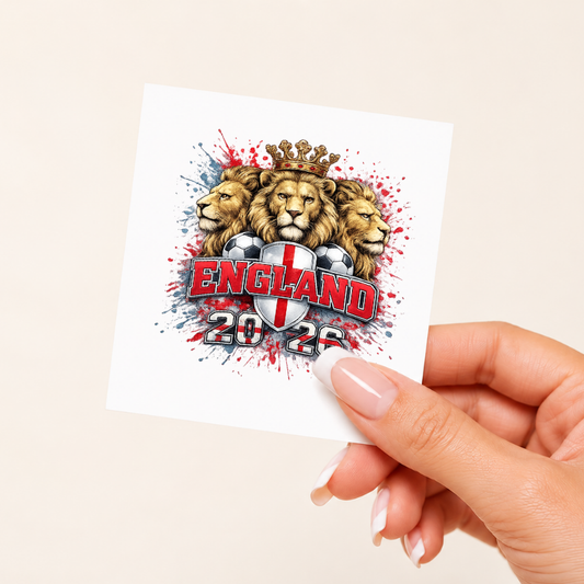 Hand holding a card with England 2022 design featuring lions and a soccer ball.